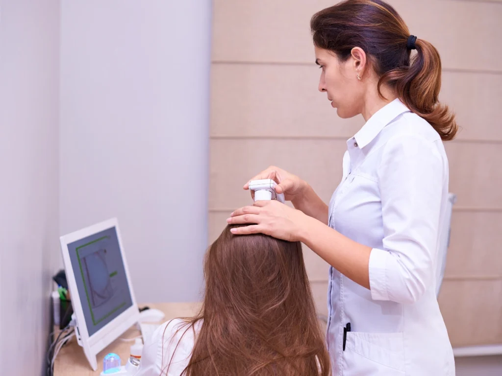 A patient receiving a professional scalp analysis to determine the best hair thinning treatment West Midlands at a hair clinic Birmingham.